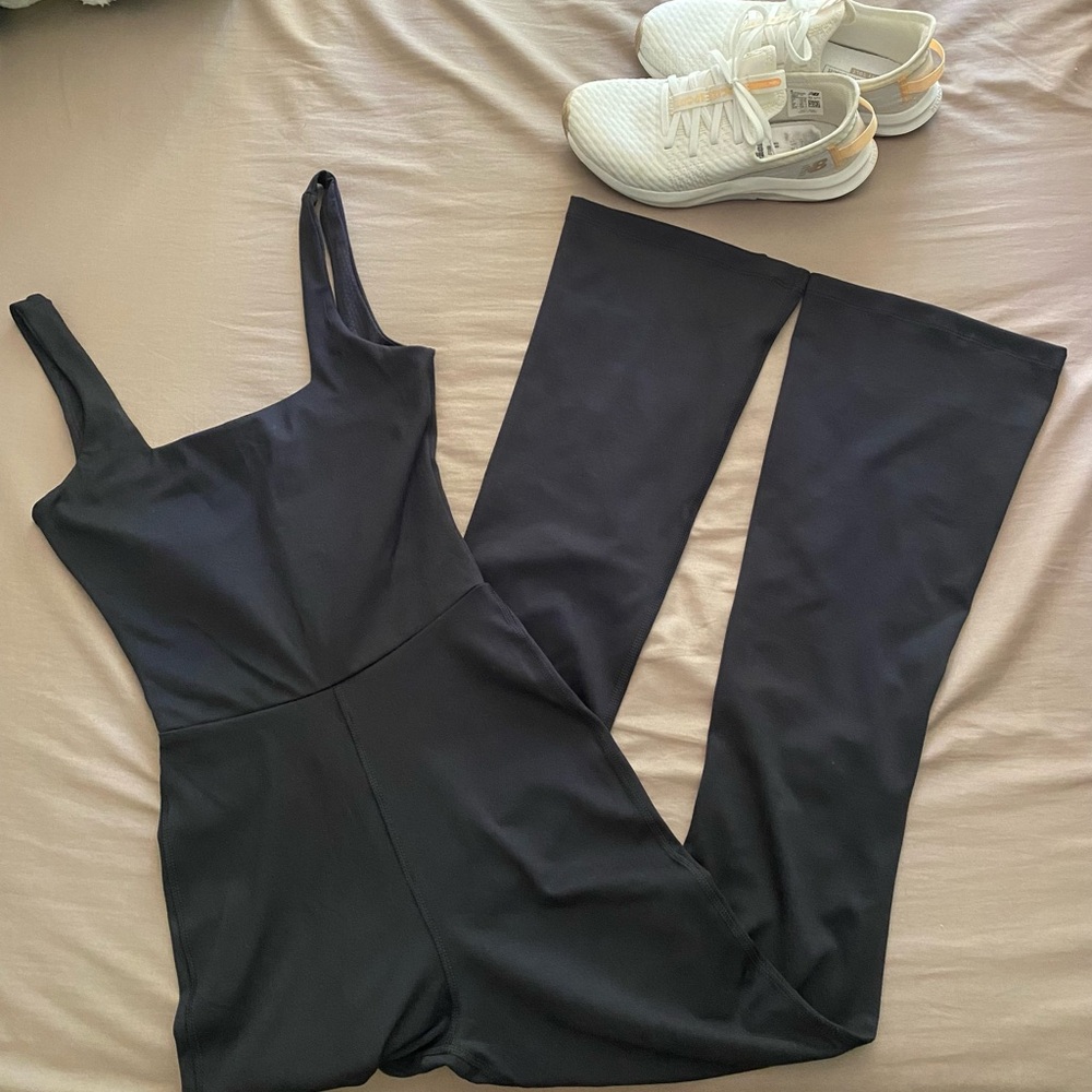 Black square neck flare leg jumpsuit. Keyhole back. Formfitting. Flattering on!
